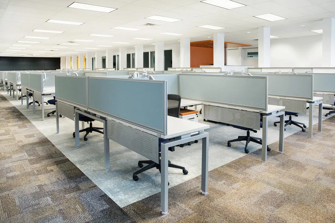Open-plan cubicle row with low panels and shared benching